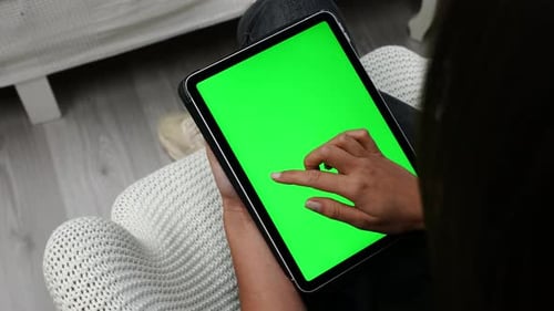Female Swiping on Tablet With Green Screen, Changing Online Pages, Close Up