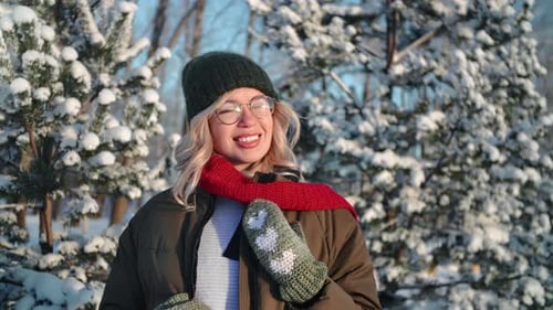 Smiling Young Beautiful Woman Relaxing Having Fun Posing at Sunny Winter Forest with Snowy Spruce