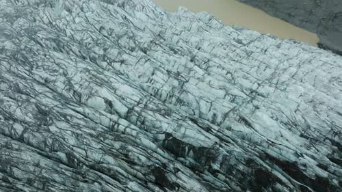 Aerial drone footage of Svínafellsjökull Glacier in Iceland, showcasing its stunning ice formations.