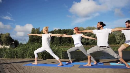 Yoga Group Warrior Pose by River