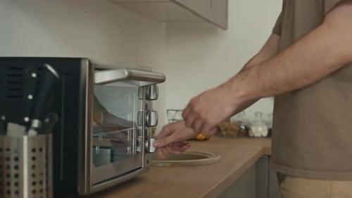 Man Puts Food in Toaster Oven