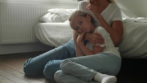 Adult Comforting Child at Home