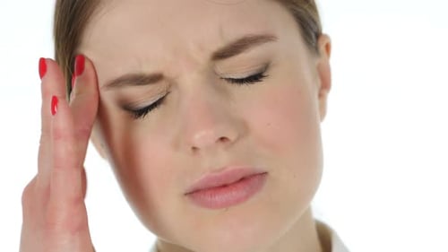 Woman Experiencing Headache, Rubbing Forehead in Pain