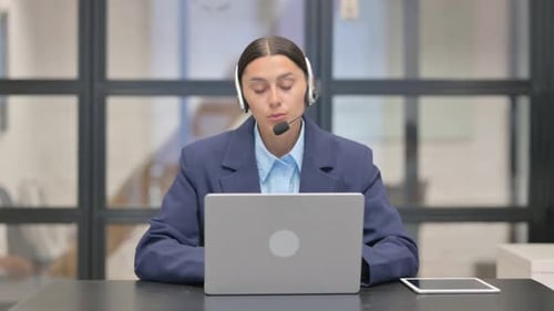 Mixed Race Woman with Headset Talking with Customer in Call Center