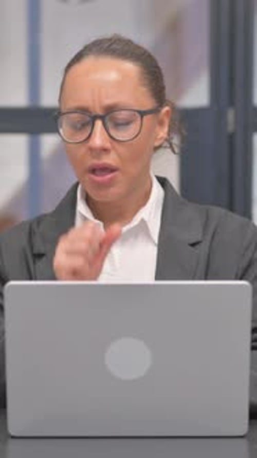 Woman Coughing While Working At Her Laptop
