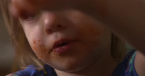 Child Eating Spaghetti with Sauce Close-Up
