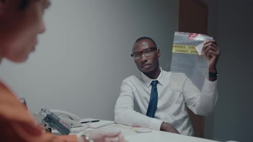 Detective Showing Evidence to Drug Dealer During Interrogation