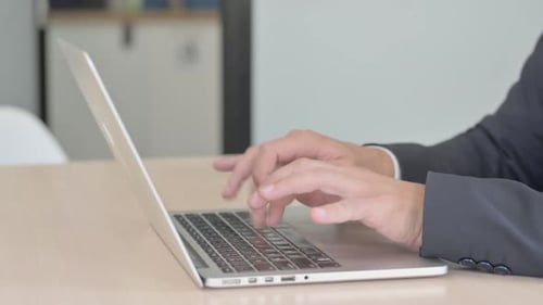 Side View of Businessman Working on Laptop