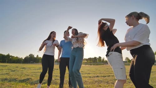 A Group of Funny Friends Dancing in the Street