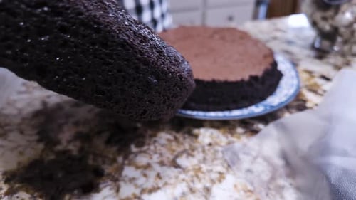 Woman Prepares Chocolate Cake Layers in Kitchen