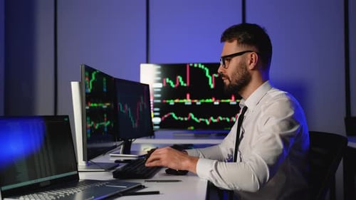 Crypto Trader Analyzing Market Charts for Investment Decisions