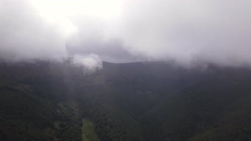 Mountains Range Shrouded in Rolling Clouds Aerial View