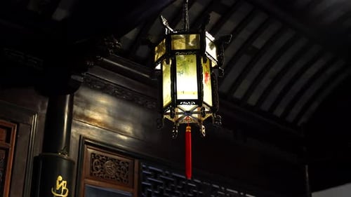 Close up shot of hanging Chinese lantern with red thread, traditional items