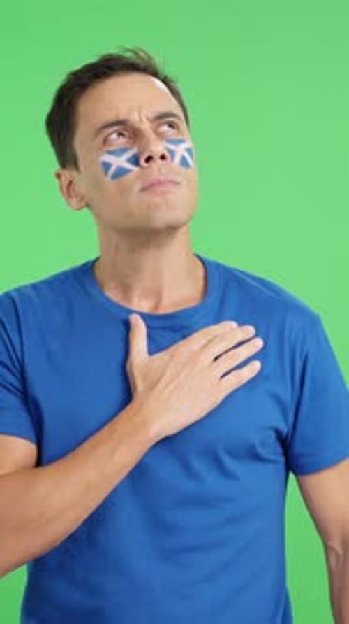 Man Listening to the Scotland National Anthem with Solemnity