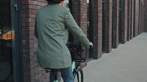 Woman With Curly Hair Riding Bicycle