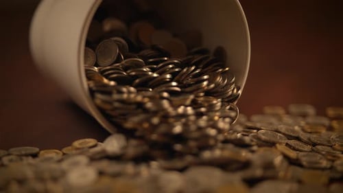 Close Up of Coins Spilling Out From Container