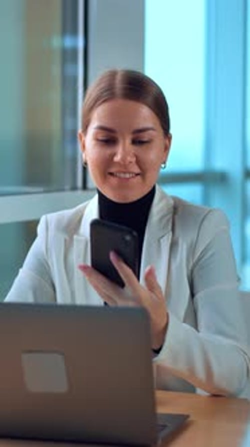 Business woman with laptop working in modern office. Young pretty manager using computer.