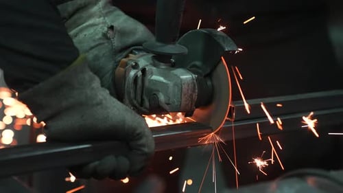 Cutting Metal With Power Tool in Factory Workshop