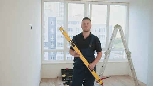 Worker Using a Ruler with a Water Level