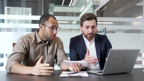 Two Men Celebrating Success in Bright Office