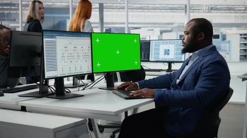 Green Screen PC Analyzing PCB Architecture and Man in Semiconductors Factory