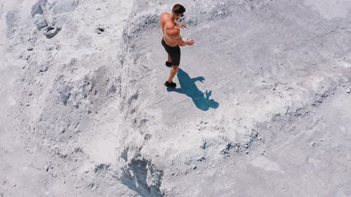 Man Walking on Rocky Landscape in Summer
