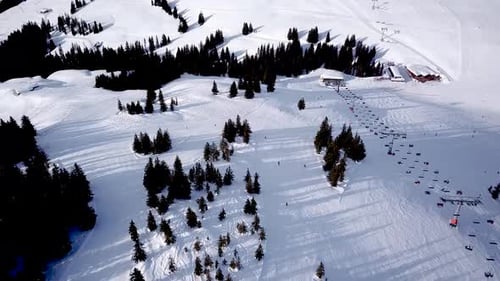 Panoramic top view from drone on cable way in ski resort. Ski lift elevator transporting skiers and