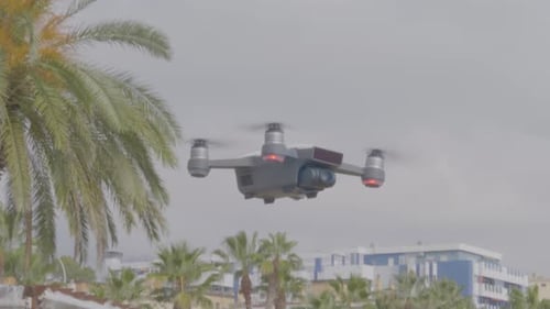 A view of a quad-copter taking off at the beach.