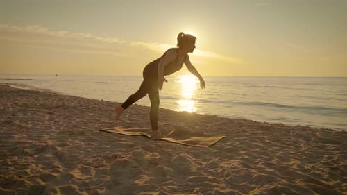 Slim Adult Woman on Beach at Beautiful Sunset Practice Yoga Breathing Techniques in Difficult