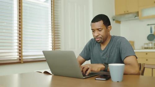 Man Working on Laptop Computer from Home