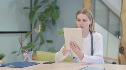 Doctor Browsing Tablet in Clinic