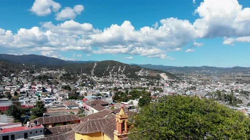 Drone landing shot from Comitan de Dominguez Chiapas San Caralampio church kiosko scenic cloud sky l
