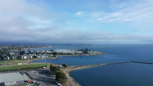 Sunny bay with clouds and fog slight rain.