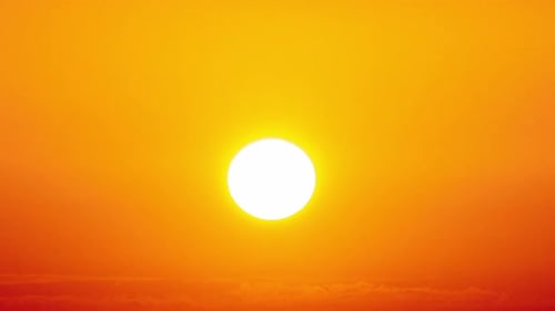 Dramatic Sunset with Sun Rays in the Sky Through Orange Layered Clouds Timelapse