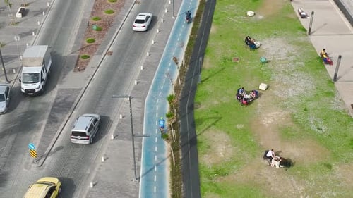 Aerial View Cyclist on a Bike Lane Along the Seafront Promenade