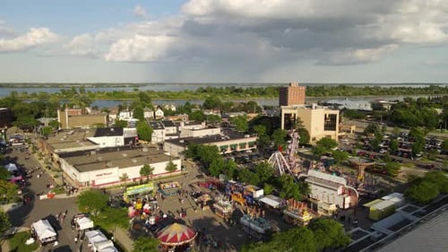 Carnival in town of Wyandotte, Michigan, with a rain storm in the background, aerial drone view