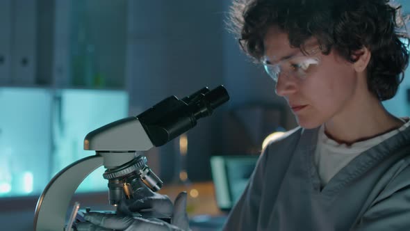 Lab Technician Placing Tissue Specimen under Microscope and Studying ...