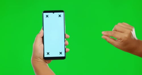 Hands, phone and mockup on green screen for social media advertising against a studio background
