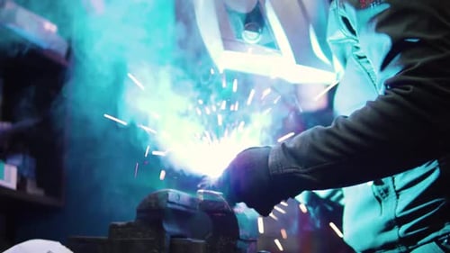 man doing heavy welding work in the garage