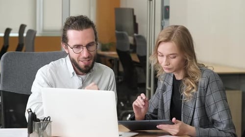 Two Professional Colleagues Working in the Office