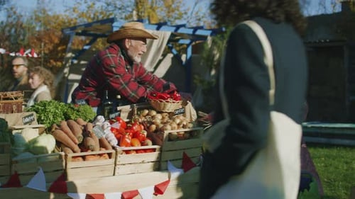 Produce Vendor Sells Vegetables at Outdoor Farmers Market