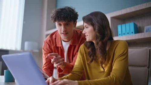 Young Adults Collaborating Around a Laptop