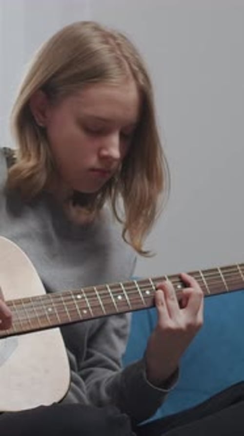 Teen Musician Practicing Acoustic Guitar Chords Indoors Focused Young Guitarist Learning Music with