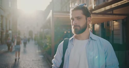 Bearded Man Smiling on Sunny City Street