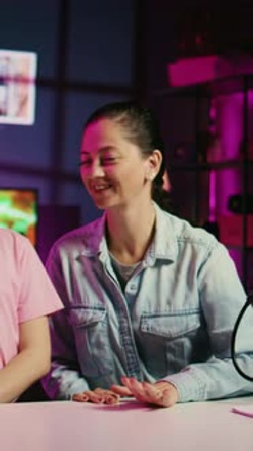 Girl and Woman Sitting at Desk Waving