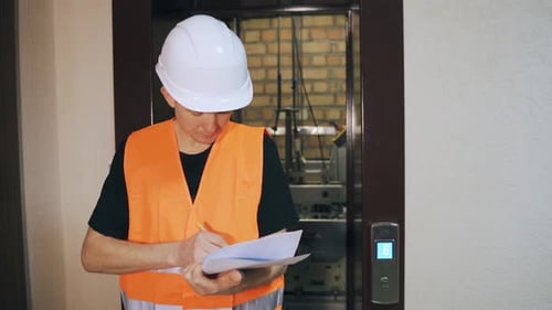 Construction Worker Doing Elevator Maintenance Thumbs Up