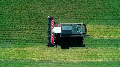 Aerial of Combines Working in the Field Harvesting Crops Gathering Season