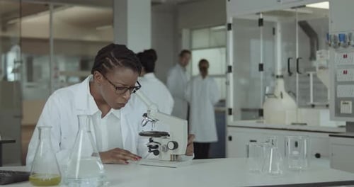 Female Laboratory Scientist Conducts Experiment in Science lab