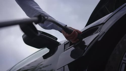 Disconnecting Charger from Black Electric Car