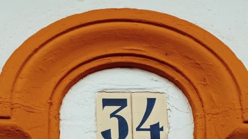 Number 34 (thirty-four) Affixed to a Building